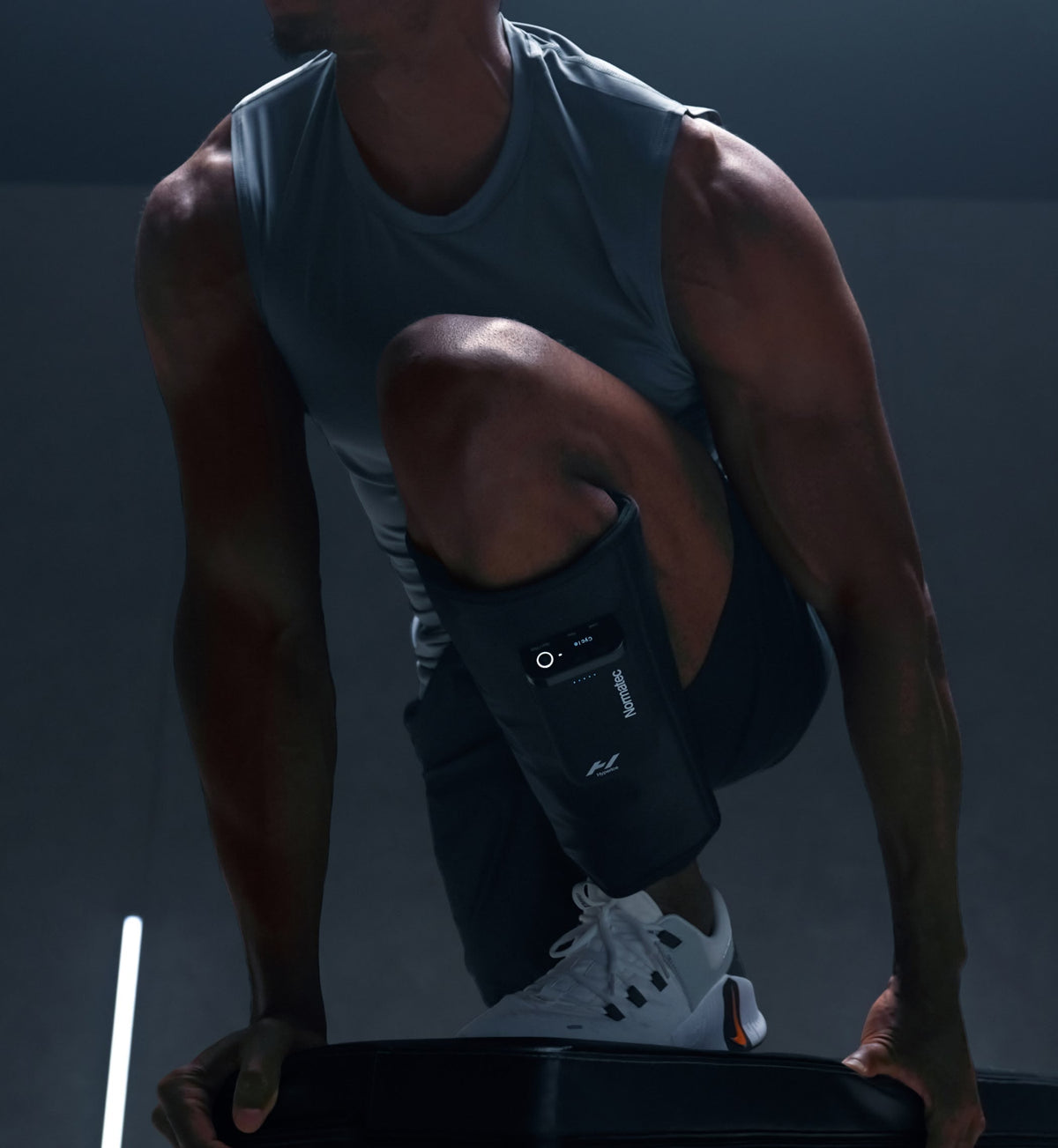 Athlete in a gym wearing Normatec Lower Legs